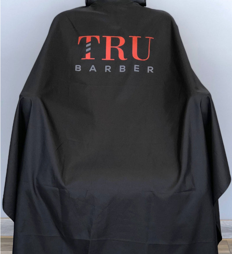 TRUBARBER PROFESSIONAL BARBER CAPE – Black With Red Letters